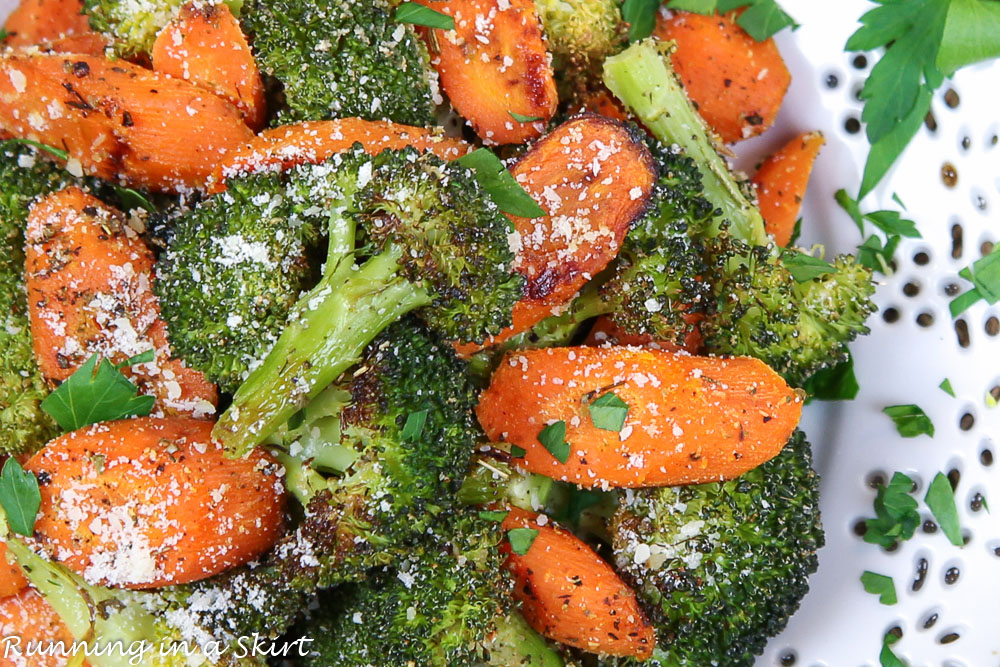 Roasted Broccoli and Carrots on a white plate close up.