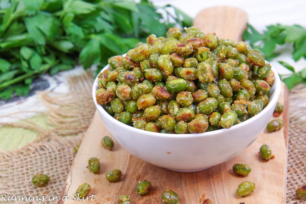 Dry Roasted Edamame in a white bowl on a cutting board.