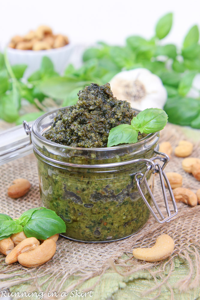 Cashew Pesto recipe in a jar with cashews on a side.