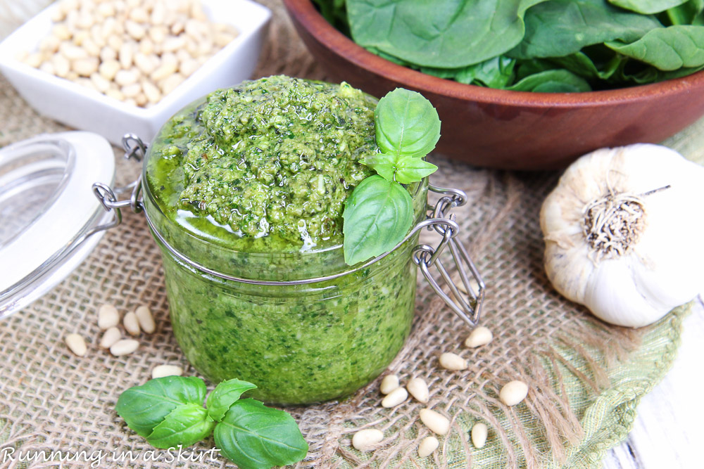 Spinach Pesto recipe in a jar with garlic and pine nuts.