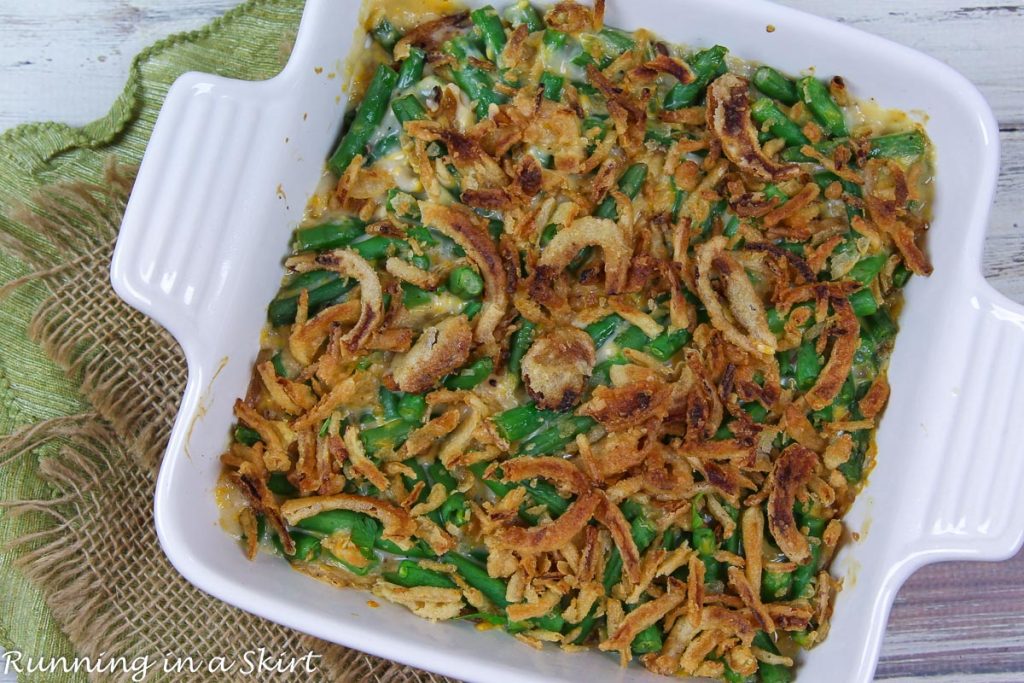 Cheesy Green Bean Casserole with fresh green beans in a casserole dish.