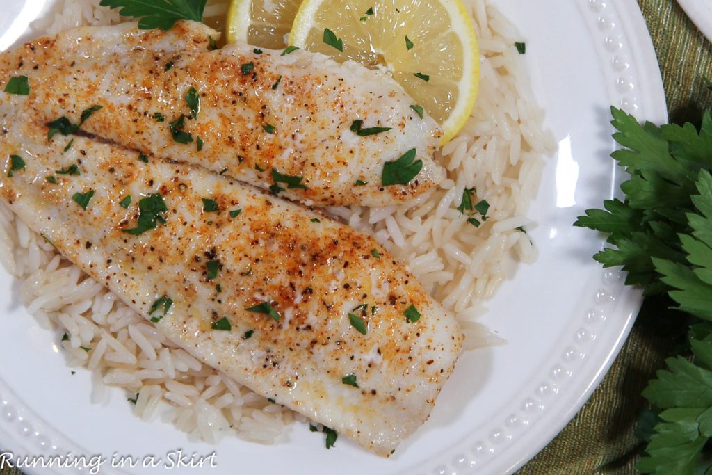 Baked Flounder recipe on a white plate with rice.